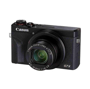 Angled front view of the premium black Canon PowerShot G7 X Mark III showing the f/1.8-2.8 bright lens.