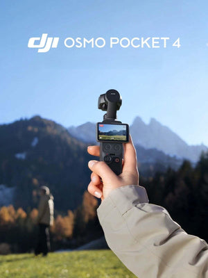 Holding the DJI Osmo Pocket 4 gimbal camera in hand during an outdoor mountain adventure trip, demonstrating portability.