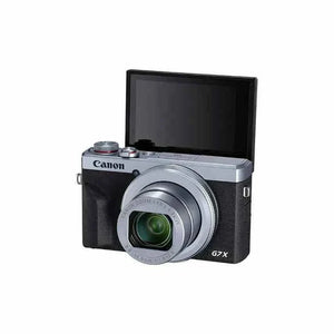 Front view of the silver and black Canon PowerShot G7 X Mark III with its 180-degree flip screen raised for vlogging