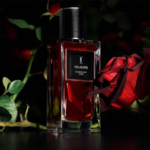 عطر من سان لوران مع وردة حمراء وشريط