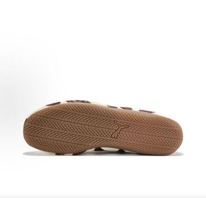 Puma Speedcat Ballet cow print brown white shoes bottom view showing gum rubber outsole pattern.