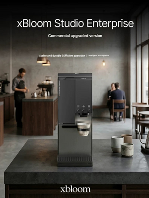 Matte black xBloom Studio Enterprise commercial automatic coffee machine placed on a dark countertop inside a modern specialty coffee shop.
اكس بلوم ستوديو
اكسبلوم ستوديو