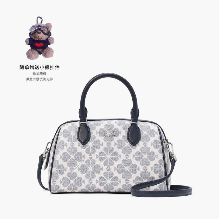 Kate Spade handbag with clover pattern, gray and dark blue, elegant design.