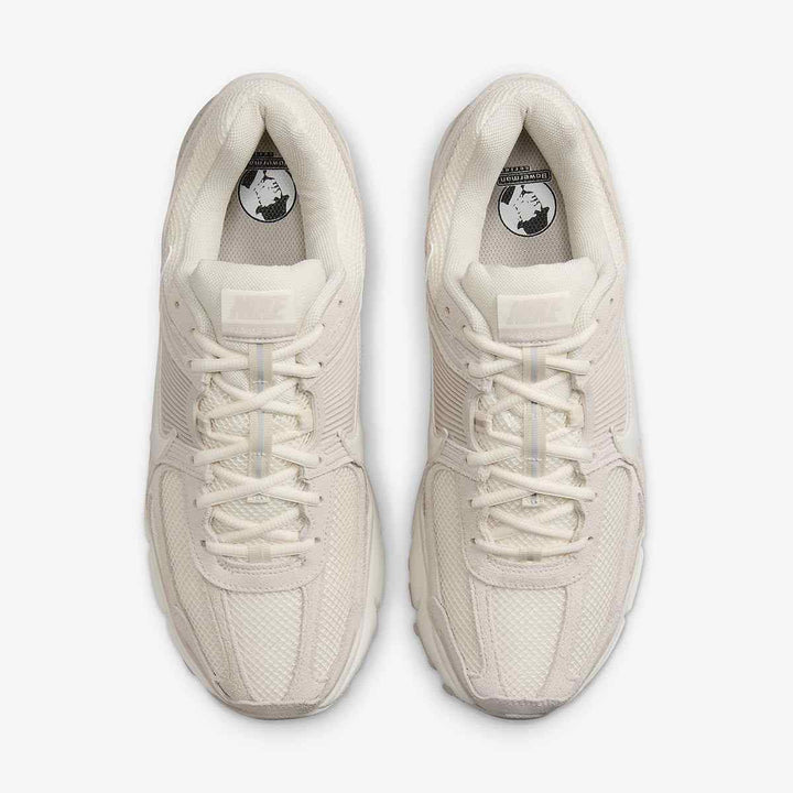 Nike Zoom Vomero 5 in ivory with mesh and leather design, featuring Zoom Air technology for comfort and durability.