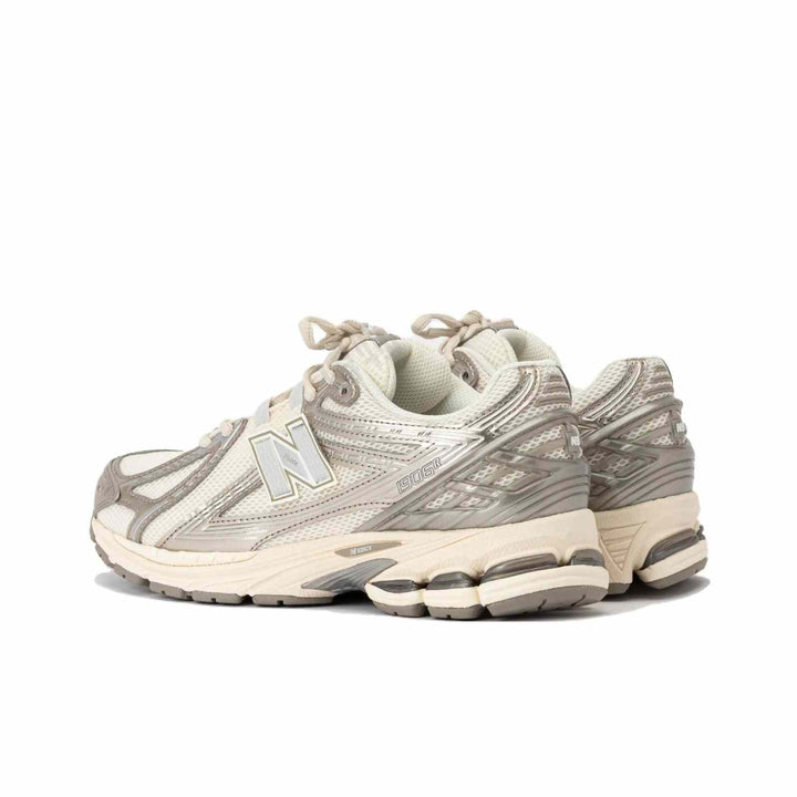 New Balance 1906R beige sneaker with silver accents and N-ERGY sole technology for comfort and durability