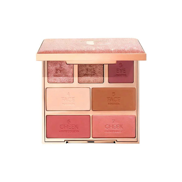 مجموعة مكياج العيون إكزاجر-آيز من شارلوت بألوان روز ومشمشي وبني مع غلاف وردي لامع وتصميم مربع فاخر