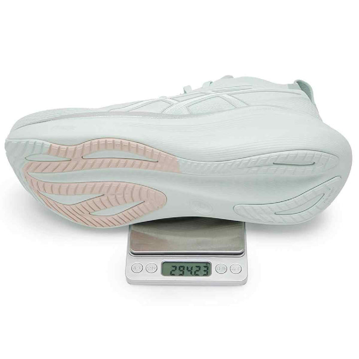 Light green Asics Gel-Nimbus 27 shoe on scale showing 294 grams, featuring sleek design and advanced cushioning technology.