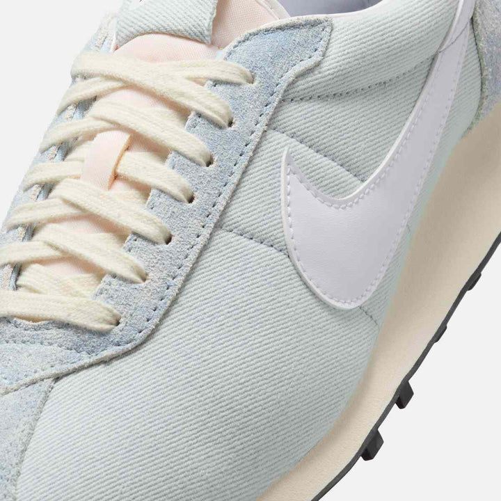 Close-up of Nike نايكي LD-1000 sneaker in pale blue denim and leather with white Swoosh and foam midsole