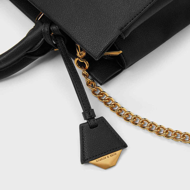 CHARLES&KEITH Mirabel top handle black bag with gold accents and adjustable strap.