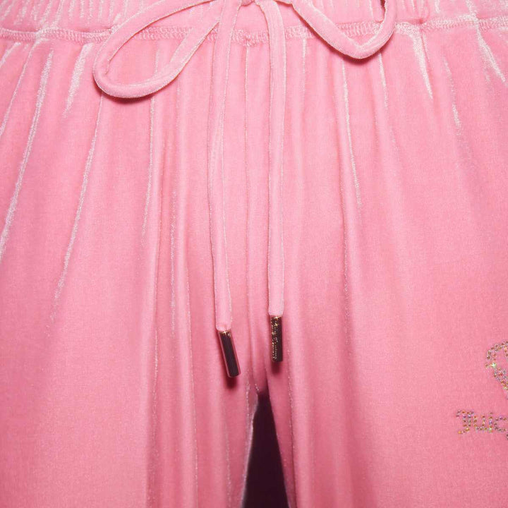 Juicy Couture pink velvet trousers with embroidered logo and gold-accented drawstring.