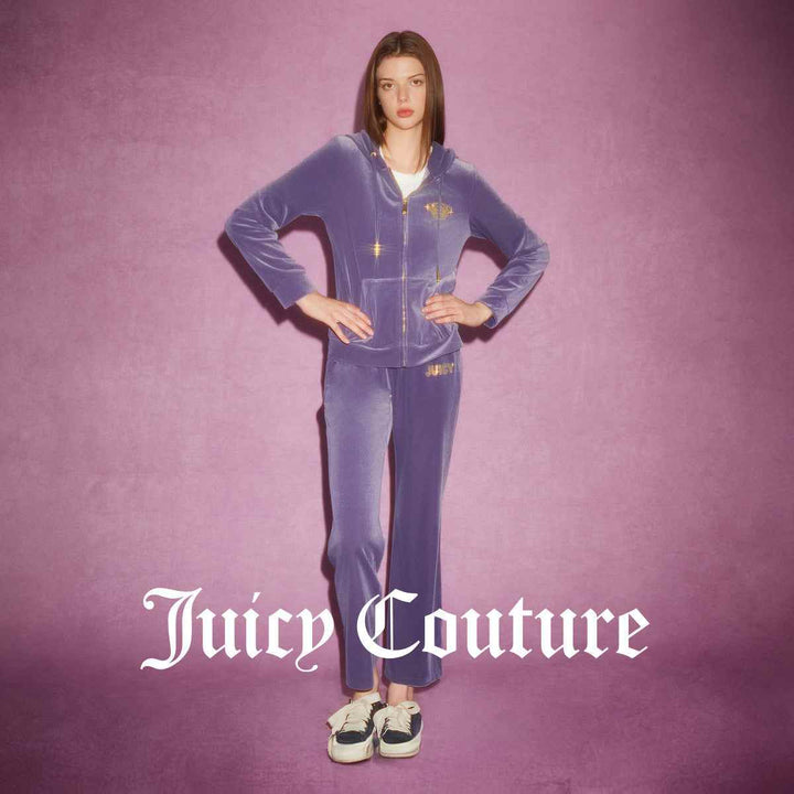 Juicy Couture purple velvet pants with 'JUICY' embroidery, luxurious design.