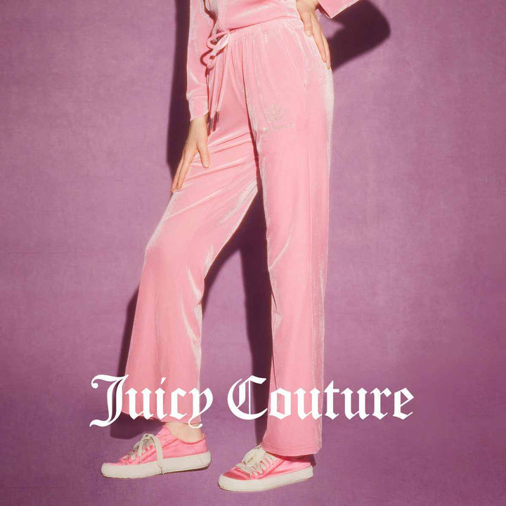 Juicy Couture pink velvet pants with wide cut and elastic waistband, featuring elegant embroidery and gold metal accents.