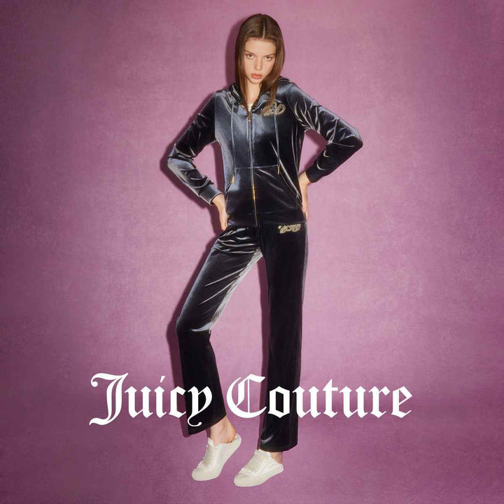 Juicy Couture velvet black pants with crystal logo and gold-accented drawstring, combining luxury and comfort.