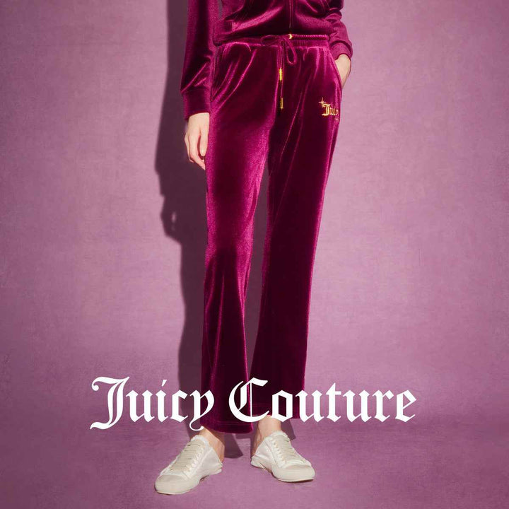 Juicy Couture velvet pants with gold button accents and embroidered logo.