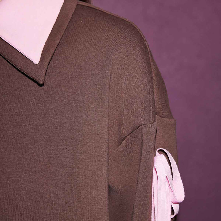 Brown and pink sporty blouse by Juicy Couture with polo collar and long sleeves.