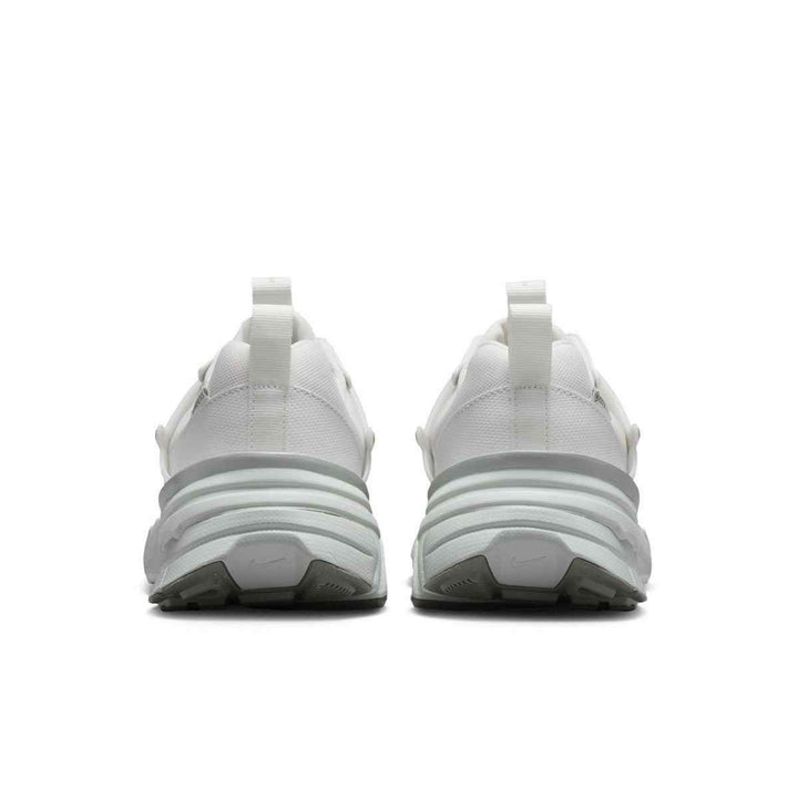 White and faded green Nike Zoom 5 sneakers with modern design and durable outsole.