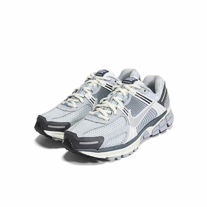 Women's Nike Zoom Vomero 5 sneakers in modern gray design with white accents, synthetic leather, breathable mesh, shock-absorbing technology, adjustable laces for comfort.