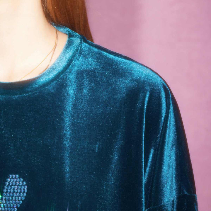 Juicy Couture blue velvet sweater with shimmering rhinestone heart design.