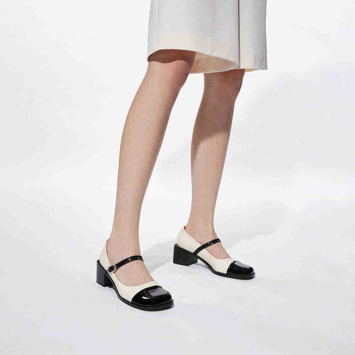 CHARLES&KEITH Mary Jane shoes in black and white with wide heels and jeweled buckle.