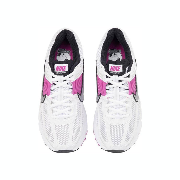 White Nike Zoom Vomero 5 with pink accents, featuring mesh design and rubber sole for comfort and stability.