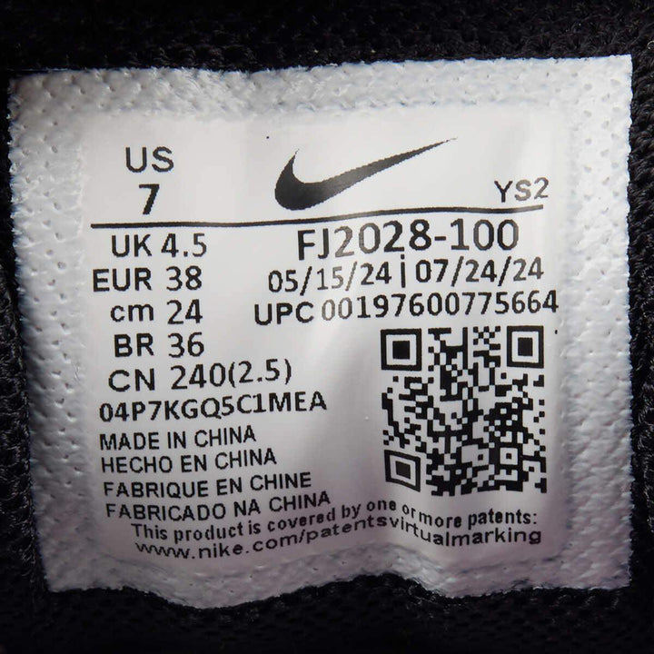 Nike Zoom Vomero 5 white with pink detail shoe label showing size and manufacturing information.