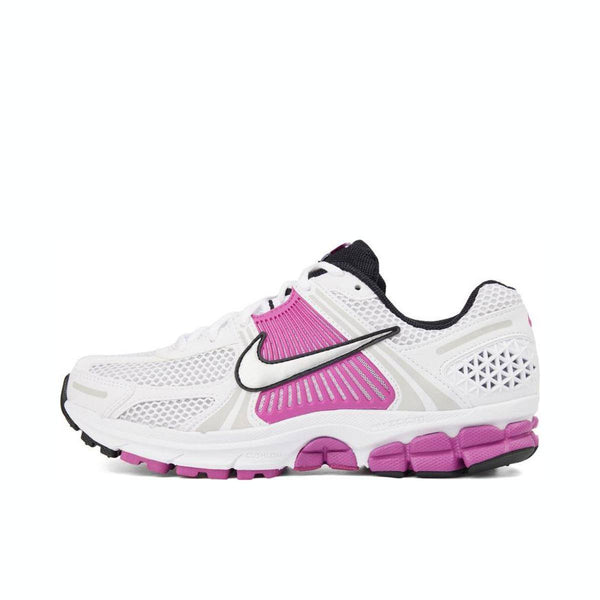 White and pink Nike Zoom Vomero 5 sports shoe with mesh design.