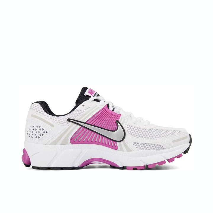 Nike Zoom Vomero 5 white and pink athletic shoe with mesh design and rubber sole.