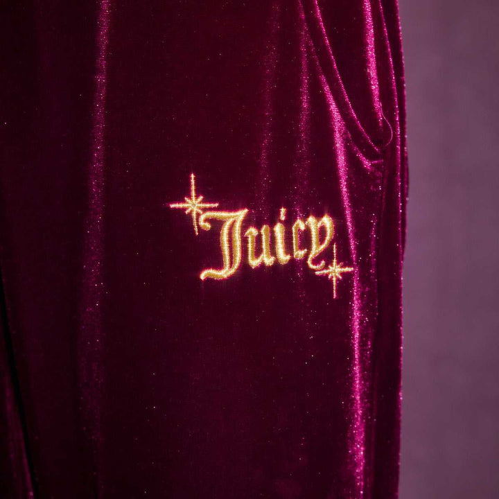 Juicy Couture velvet pants with embroidered logo, elegant and luxurious design.