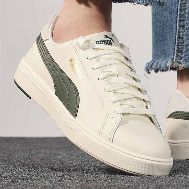 Puma ivory sneakers with an olive side stripe, classic design and gold logo.