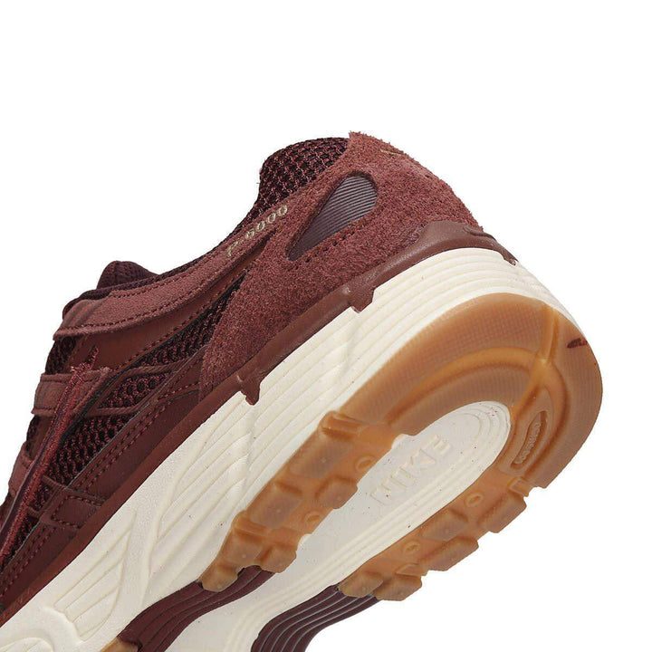 Nike P-6000 burgundy sneaker with mesh and leather design, light brown rubber sole.