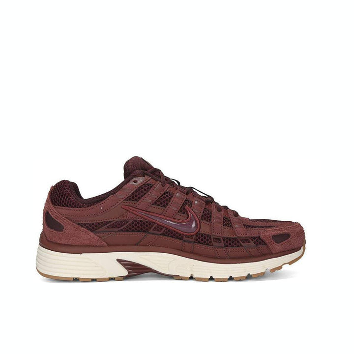 Nike P-6000 burgundy sneaker with mesh and leather design, featuring a light brown rubber sole for comfort and stability.