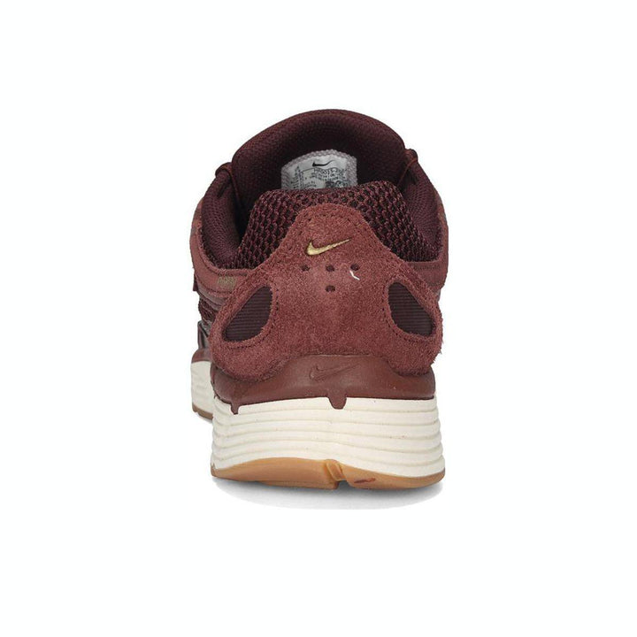 Nike P-6000 sneaker in burgundy with mesh and leather design, light brown rubber sole.