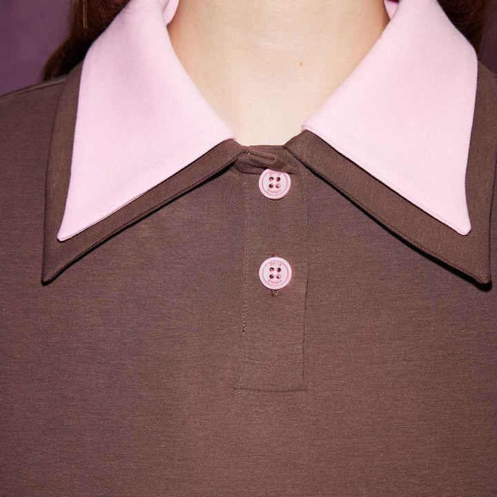 Juicy Couture brown and pink polo collar sports blouse with pink buttons.