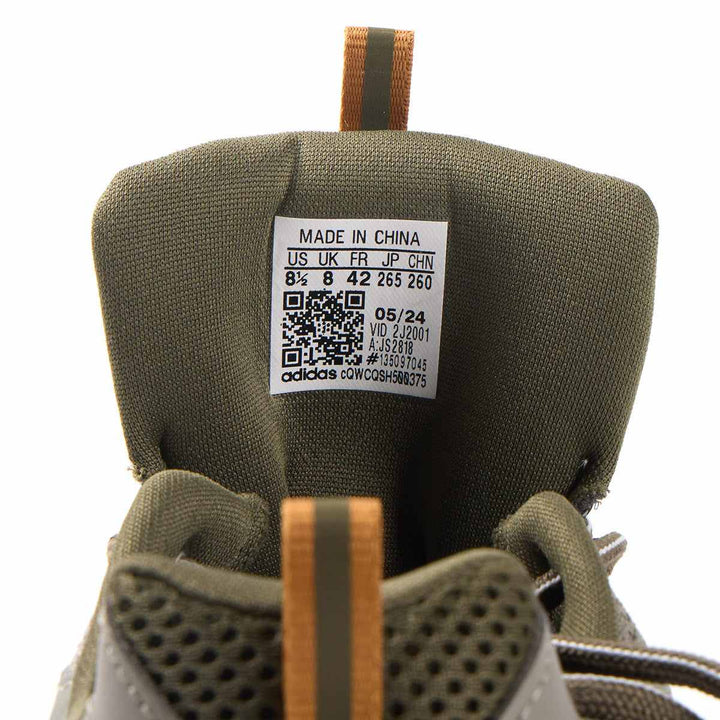 Detailed view of adidas JZ Runner sneaker tongue with size label.