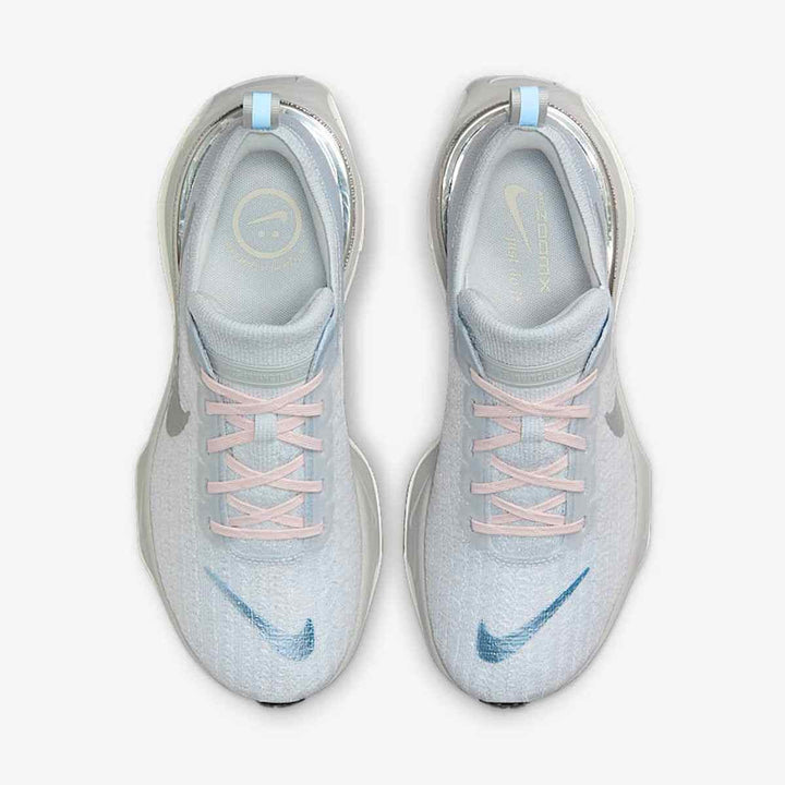 Light blue Nike ZoomX running shoes with mesh upper and reflective swoosh.