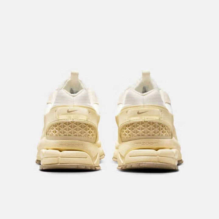 Nike Zoom Vomero luxury sneakers in pale ivory color, designed for urban conditions with durable materials and rubber mudguard.