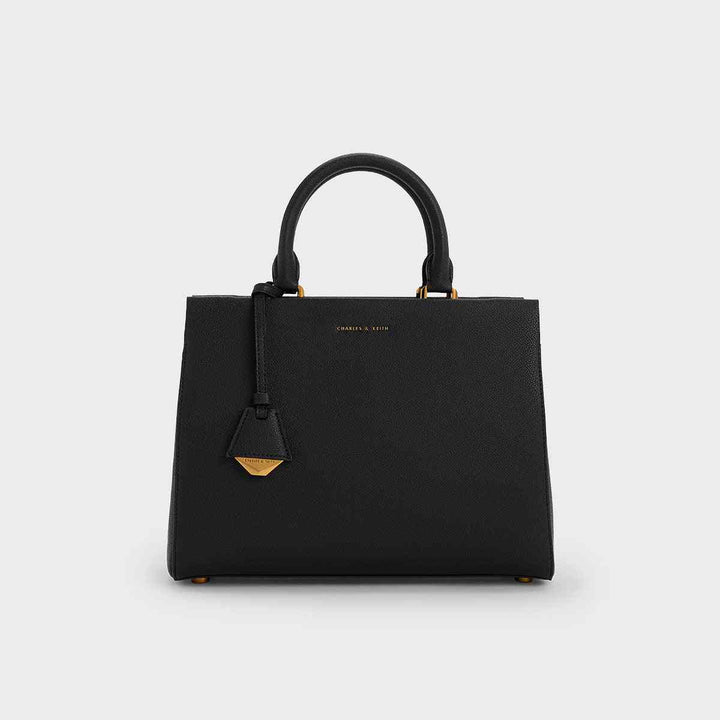 CHARLES&KEITH black Mirabel top handle bag with gold accents and detachable strap.