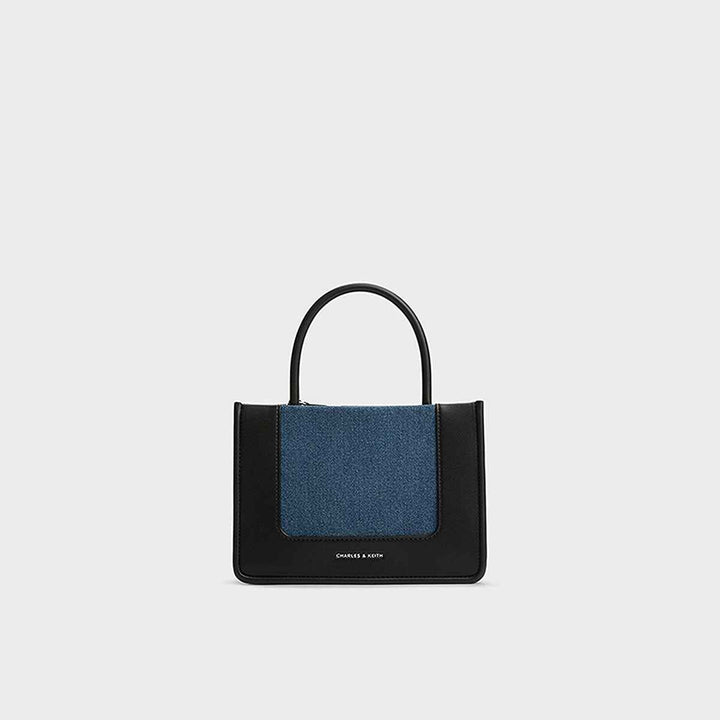 Elegant black handbag with denim accents by CHARLES&KEITH.