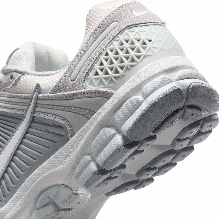 Nike VOMERO 5 women's sneakers, featuring breathable material and shock-absorbing sole, close-up view.