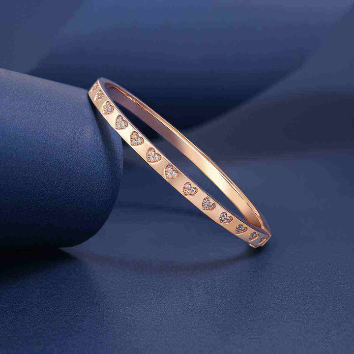 APM MONACO pink love hearts bracelet with crystal embellishments on a rose gold band.