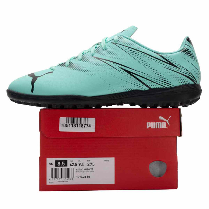 Puma turquoise and black football shoe for artificial grass on red box.