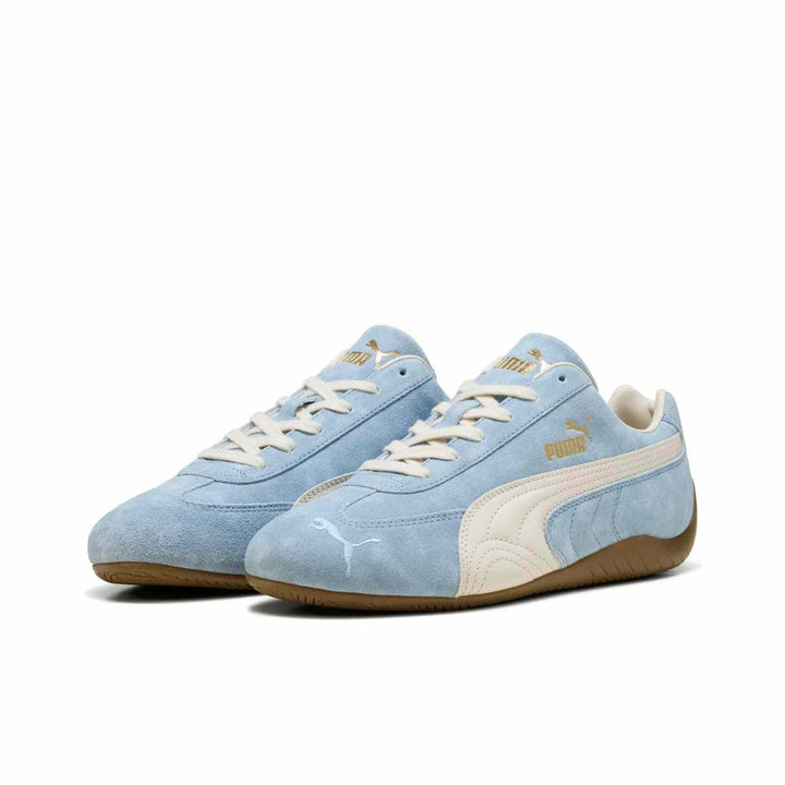 PUMA Palermo OG Vintage sneakers in light blue suede with ivory stripes and gold logo accents, brown rubber sole.