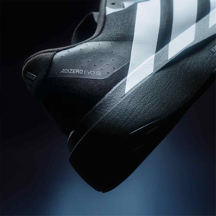 adidas Adizero running shoe in black and white, featuring lightweight design and energy-absorbing Lightstrike Pro technology.