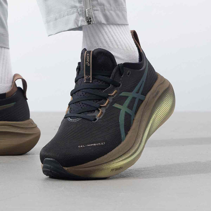 ASICS Gel-Nimbus 27 black sneakers with bronze accents, featuring advanced cushioning and grip.