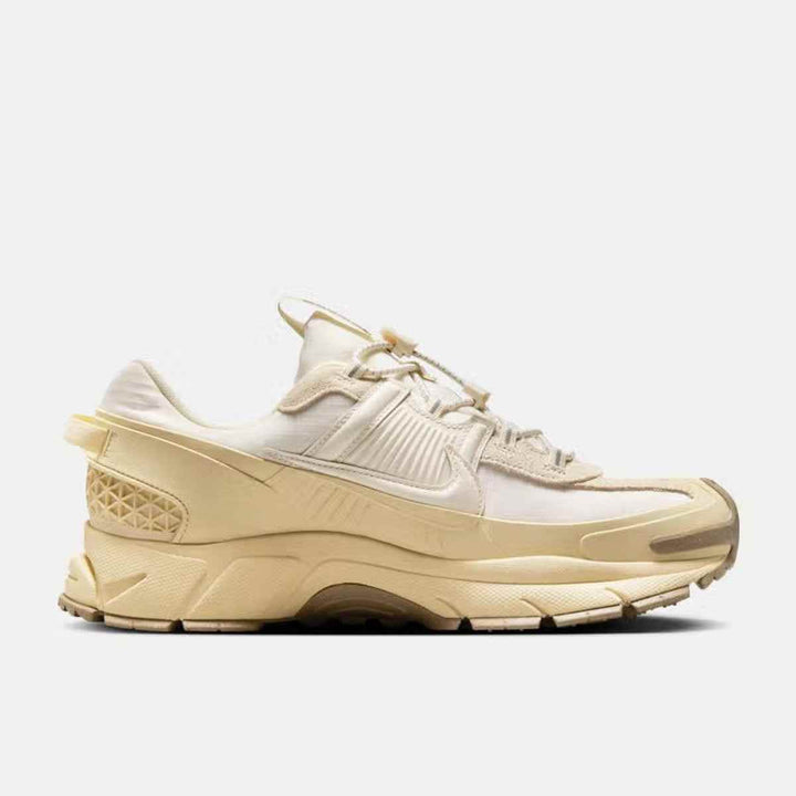 Nike Zoom Vomero luxurious sports shoe in ivory, featuring durable materials, rubber mudguard, and cushioned midsole; ideal for city weather and stylish performance.