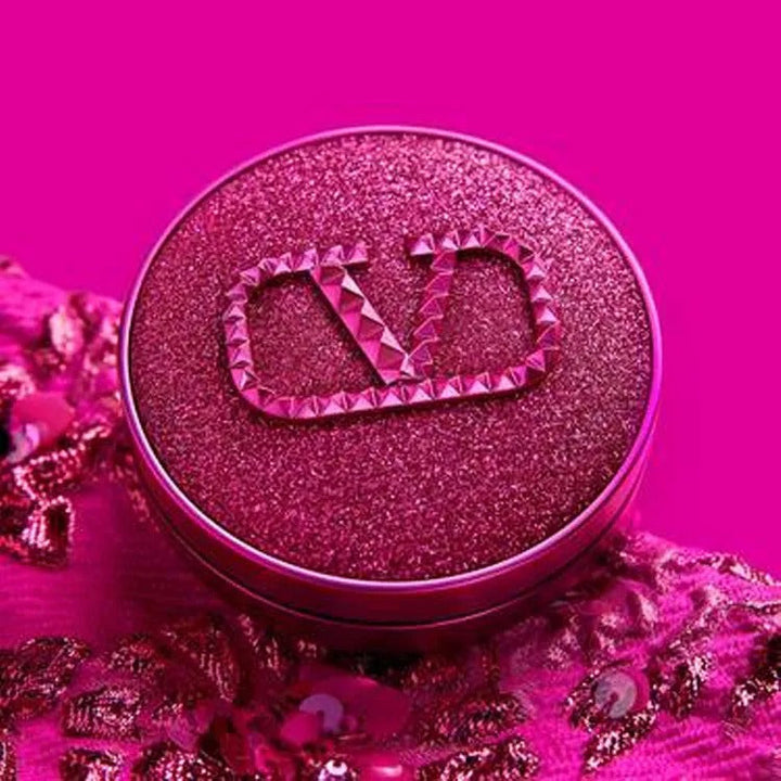 Valentino Beauty Fantasy Pink foundation compact with glittery pink lid and luxurious design on pink fabric background