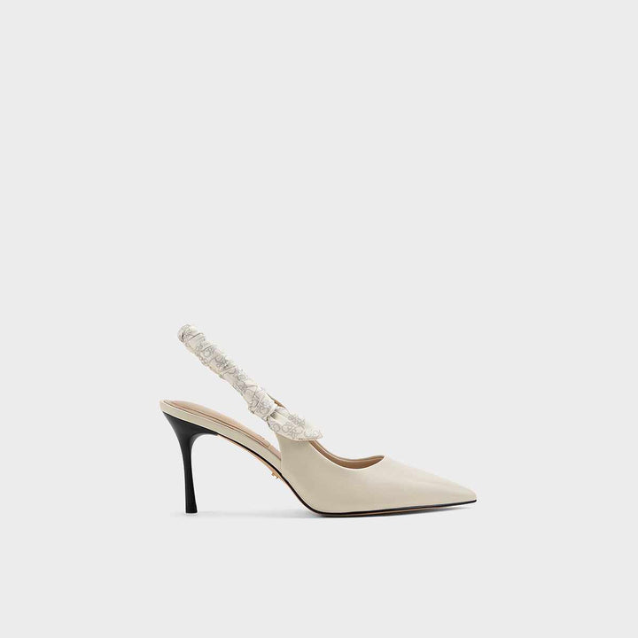 High heel shoe with patterned elastic straps by CHARLES&KEITH in cream leather, featuring a pointed toe and elegant stiletto.