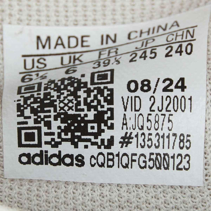 Label showing adidas shoe size and manufacturing details.