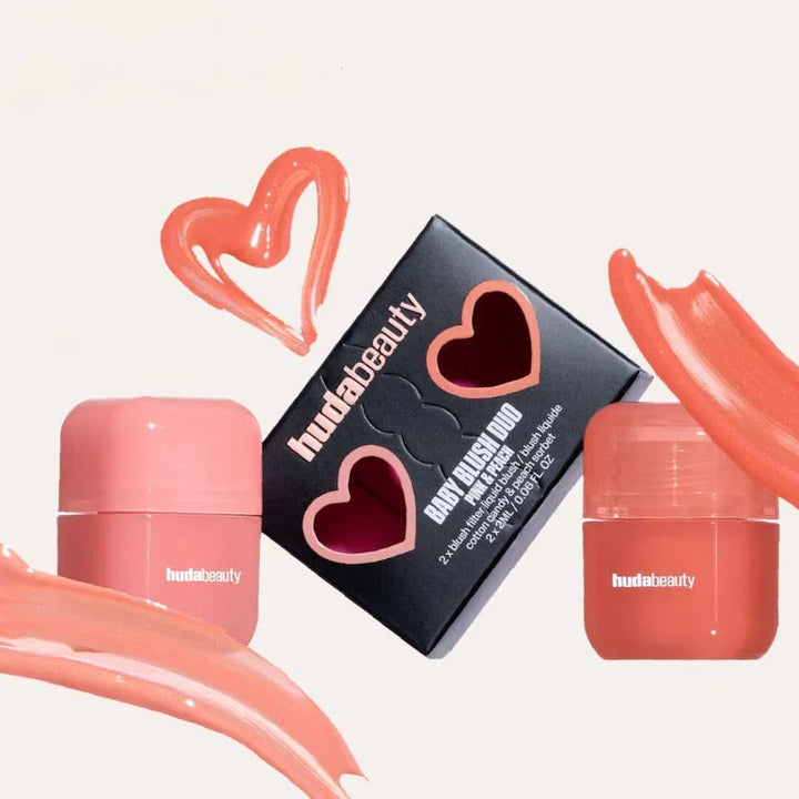 Huda Beauty Baby Blush Duo with pink and peach creamy blushes in compact containers and black packaging with heart cutouts