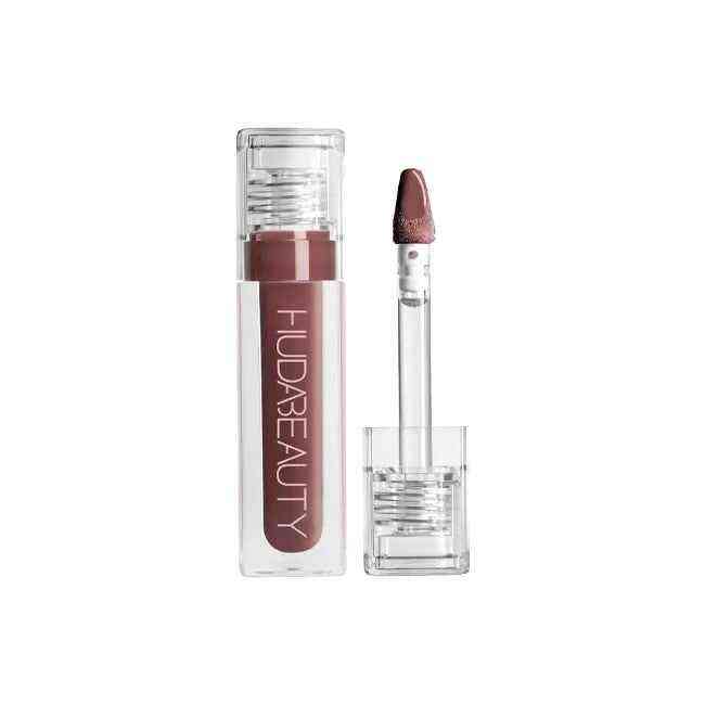 Huda Beauty Lip Gloss Collection in warm brown shade with clear tube and applicator wand showing silky smooth texture and glossy finish.